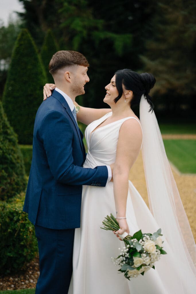 Bride and groom embrace at their River Barn wedding