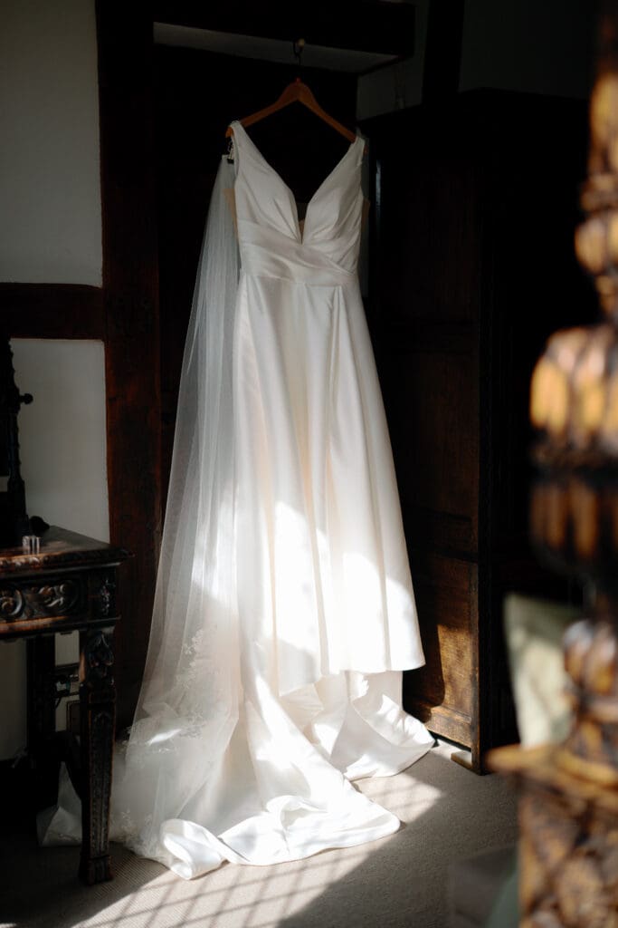 Lucy's wedding dress hanging in the River Barn's bridal suite, by Nessworthy Pictures